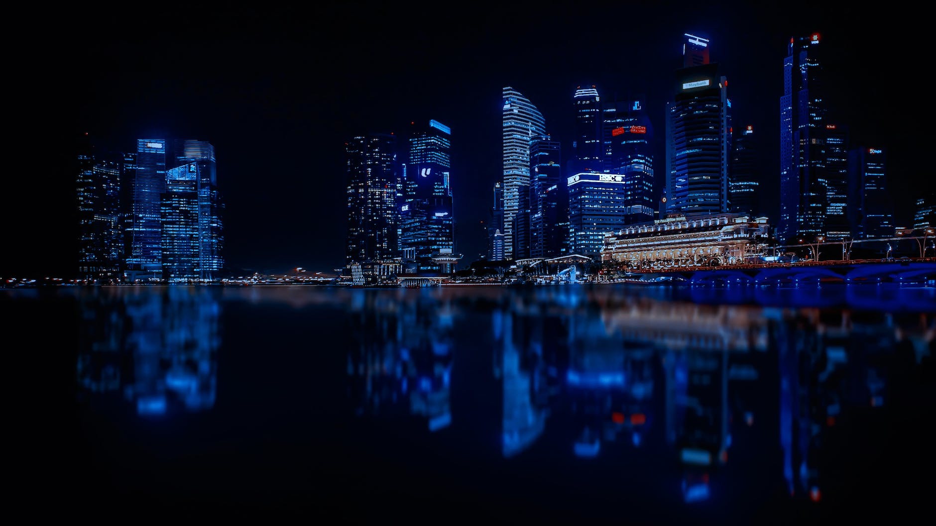 Illuminated Cityscape Against Blue Sky at Night